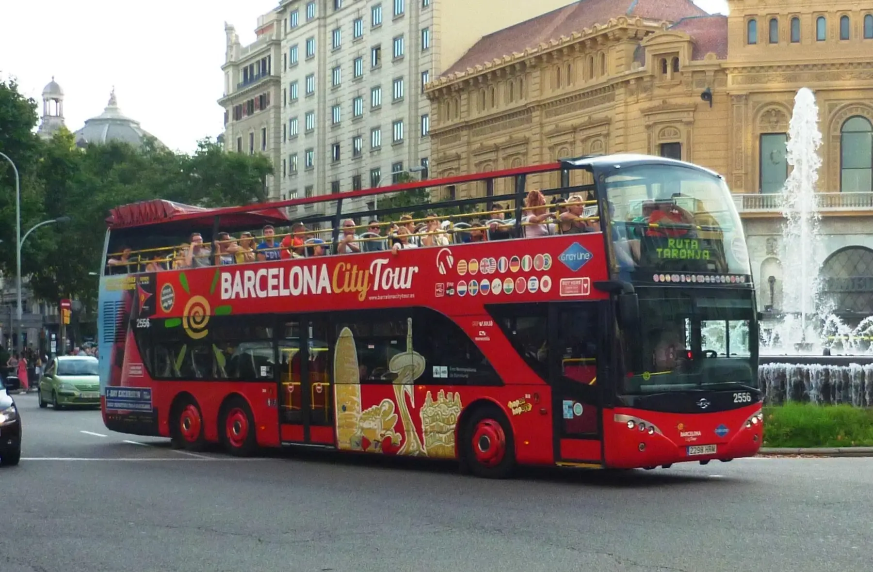 A red Barcelona City Tour double-decker near Plaça d'Espanya